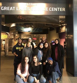 Students pose by the entrance to the Great Lakes Science Center