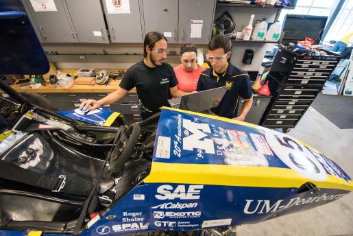 3 students working on SAE car