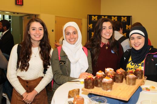 4 students standing in front of delicious desserts