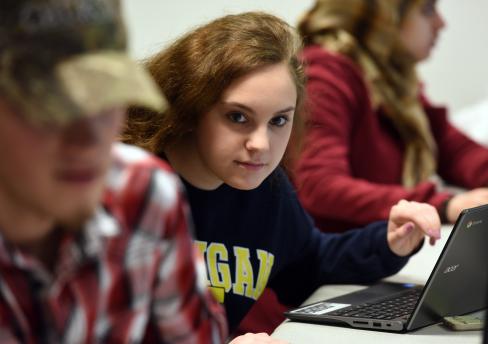 Female student with Michigan sweatship intensely watching