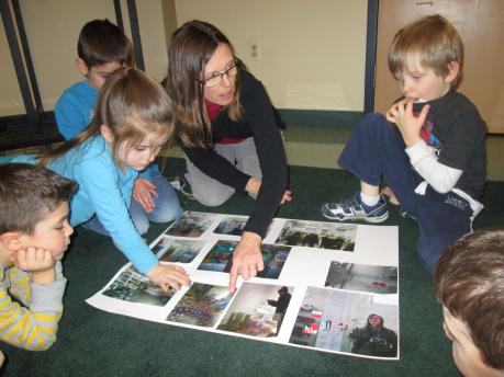 Young children looking at pictures on the floor