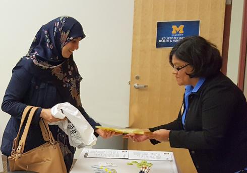 Female student wearing hijab meeting with staff member in the College of Education, Health & Human Services