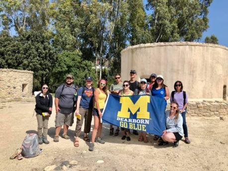 Group of students hold UM-Dearborn flag in Cyprus