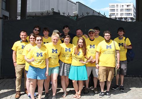 Group of people wearing maize UM-Dearborn shirts on Poland Study Tour