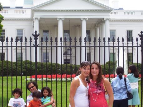 2 females pose for photo in front of the White House.