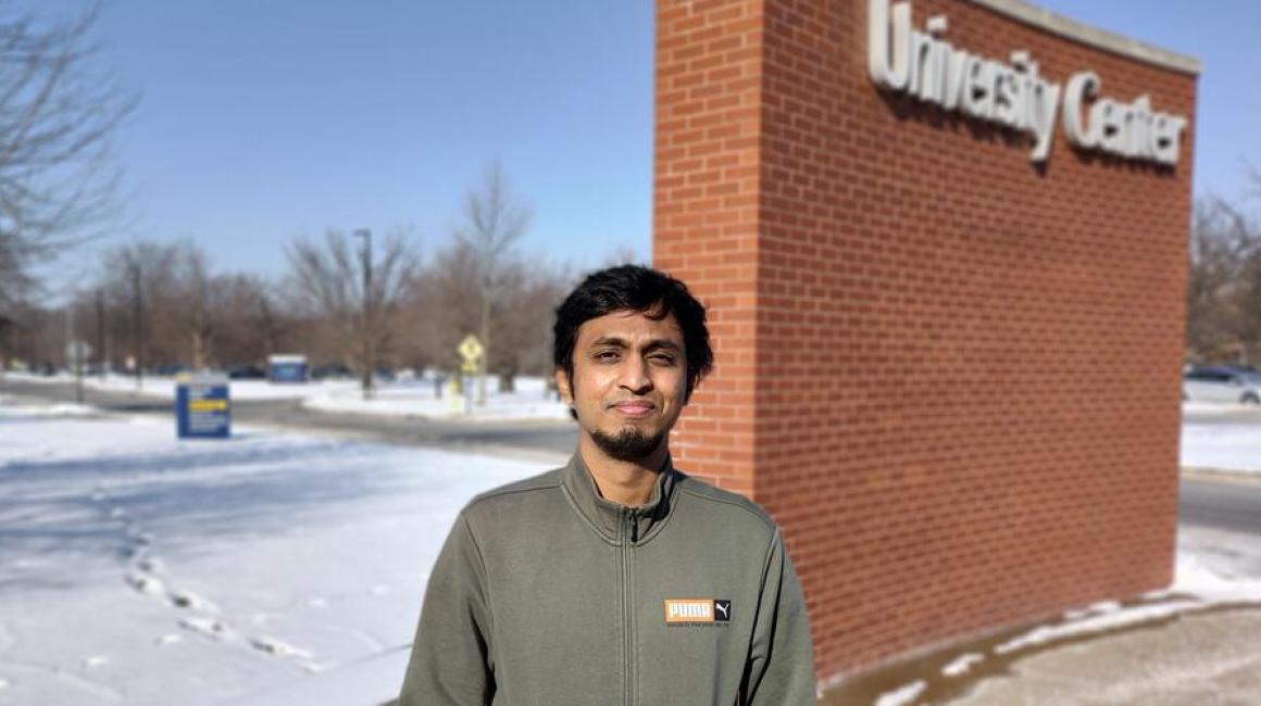 Although he is not a fan of the cold, Ruthvik Sankar braves the snowy weather for a photo outside of the University Center. Photo by Rudra Mehta
