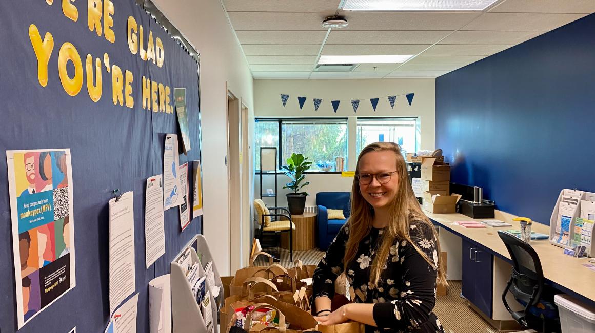 Dearborn Support Coordinator Maddie Drury sorts food for the Student Food Pantry in the Dearborn Support office suite, which is on the second floor of the University Center.