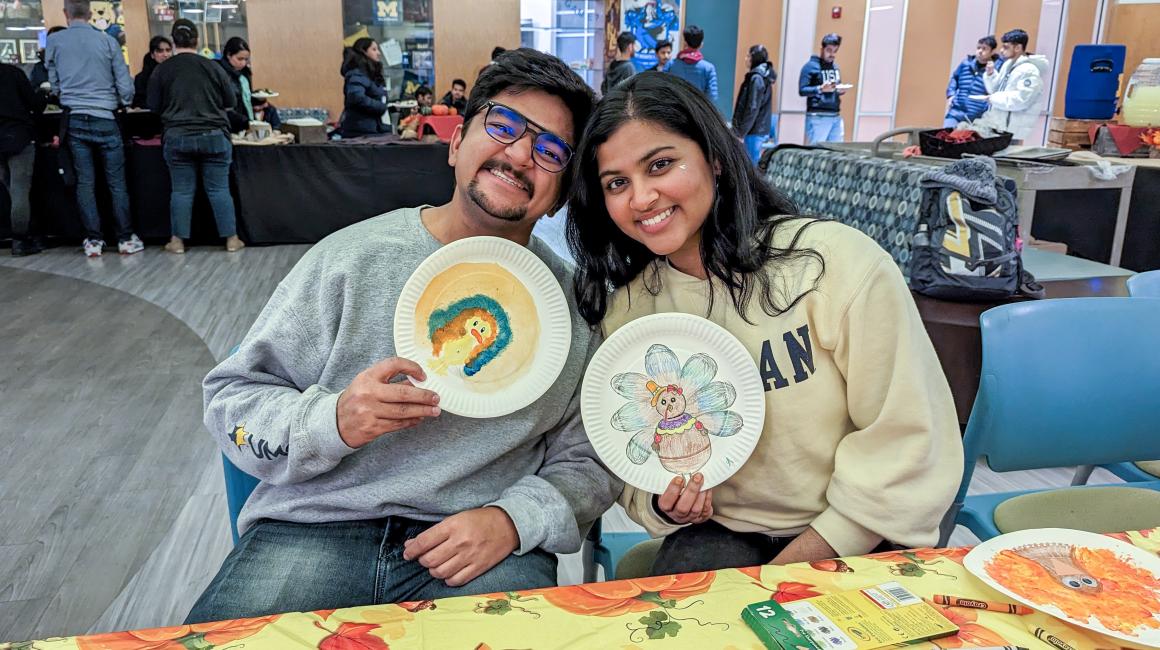 Graduate student Fenil Chapatwala and sophomore Gayathri Chava DIY some holiday decorations at the 2022 UM-Dearborn Friendsgiving.