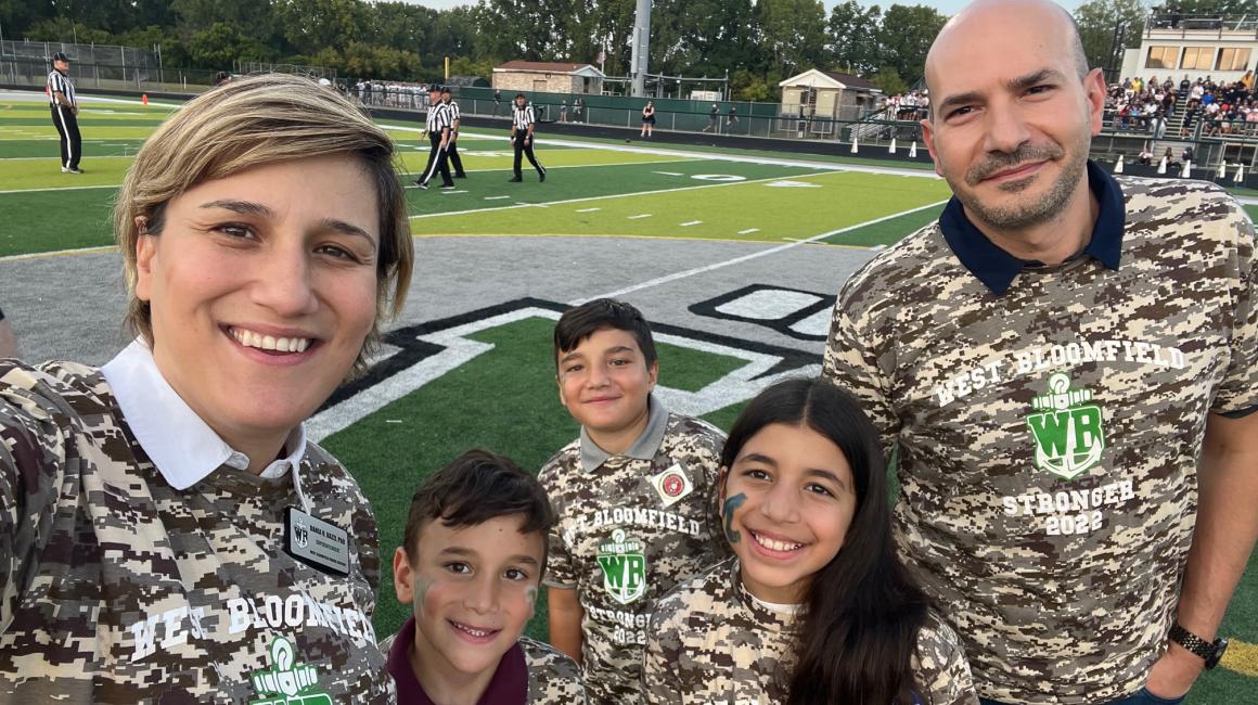 Dania Bazzi poses for a selfie with her husband, two sons, and niece at a West Bloomfield high school football game