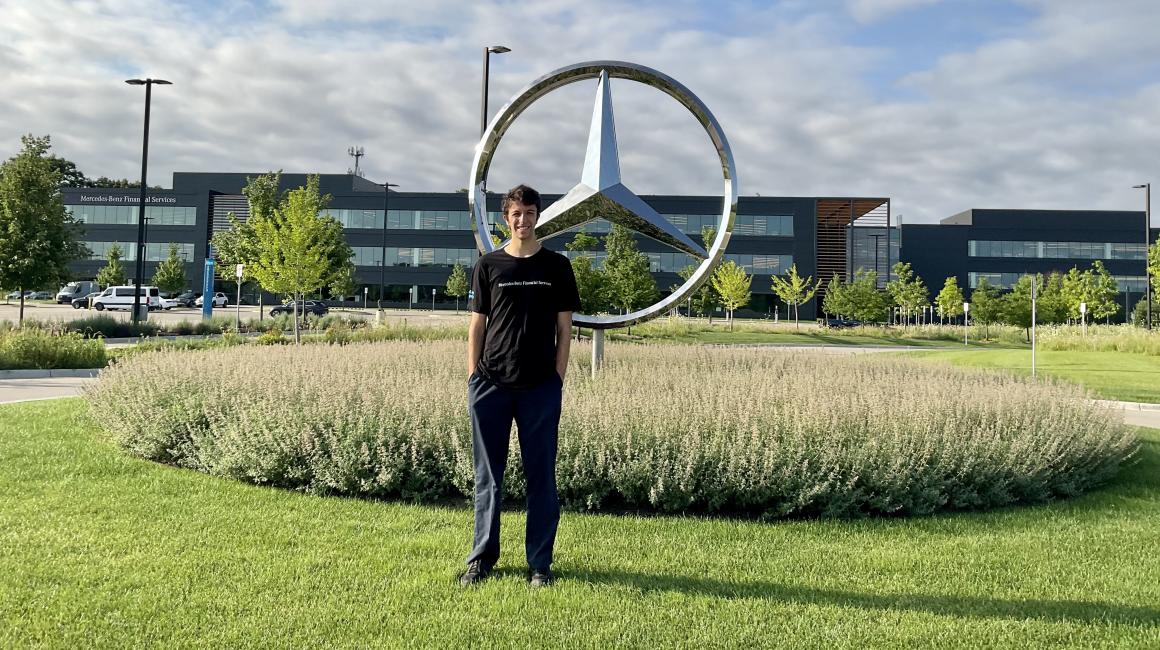 Senior Archie Lytle stands outside of Mercedes Benz Financial Services Building