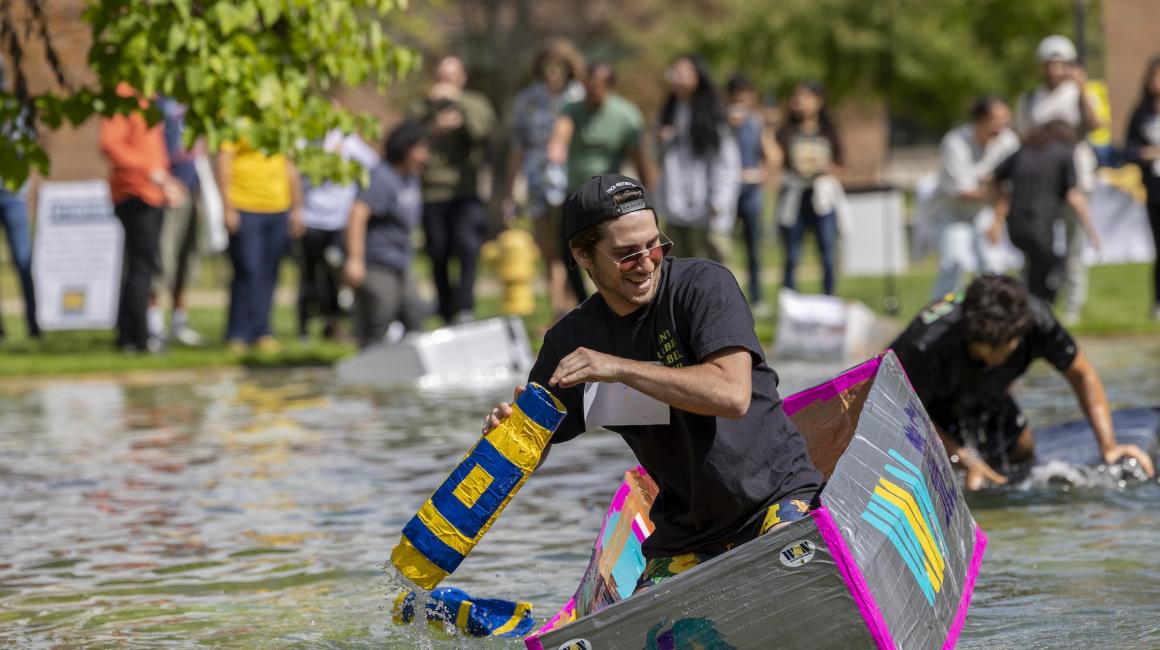 Man in cardboard boat in the pond