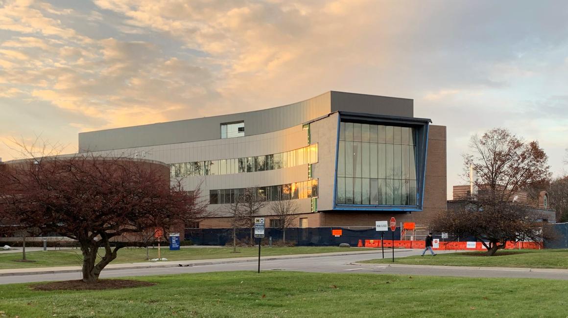 The front face of the Engineering Lab Building under construction during sunset.