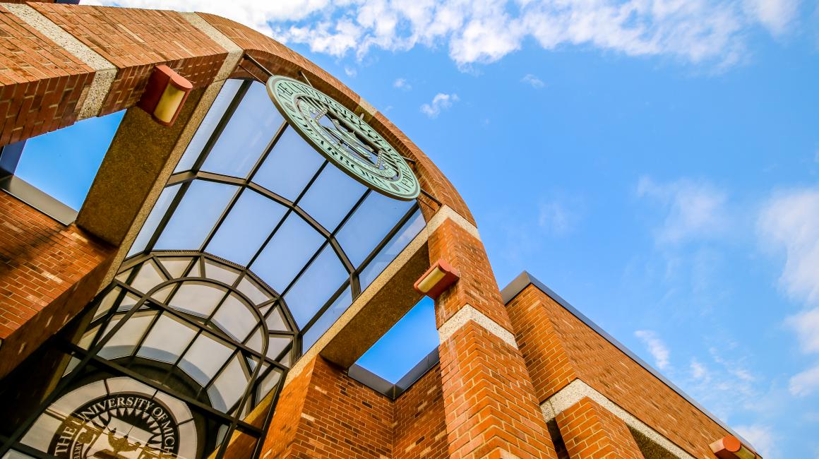 An artistic shot of the university seal on the Social Sciences Building set against a blue sky