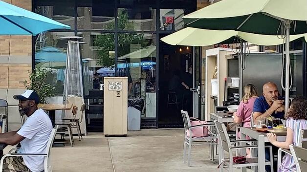 Customers eat seated on a Downtown Dearborn restaurant's patio seating.