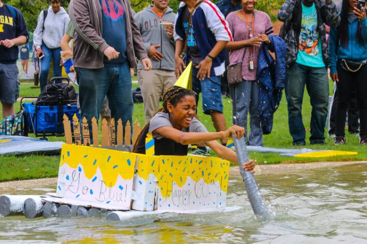 Students try to make it across the Chancellor's Pond during the annual Cardboard Boat Races.