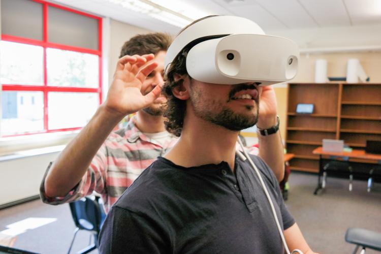 Two students using a virtual reality headset