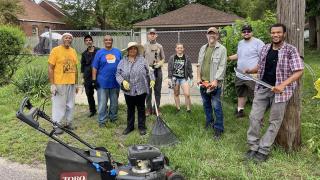 Professors and Detroit residents cleaning outdoor spaces.
